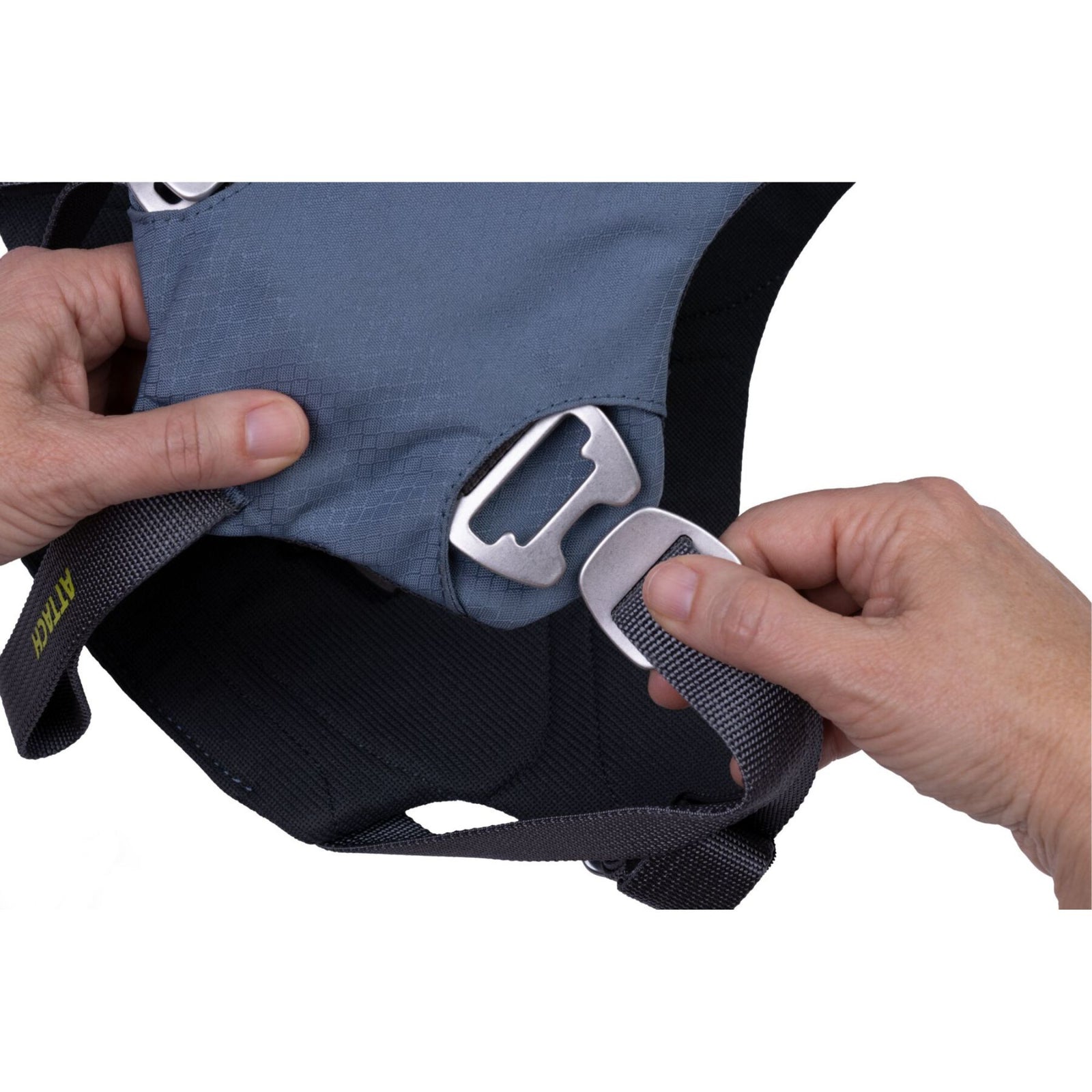 Close-up of the forged anodised aluminium slide buckle on the Ruffwear Load Up dog car harness in Slate Blue, with the ATTACH seatbelt loop visible